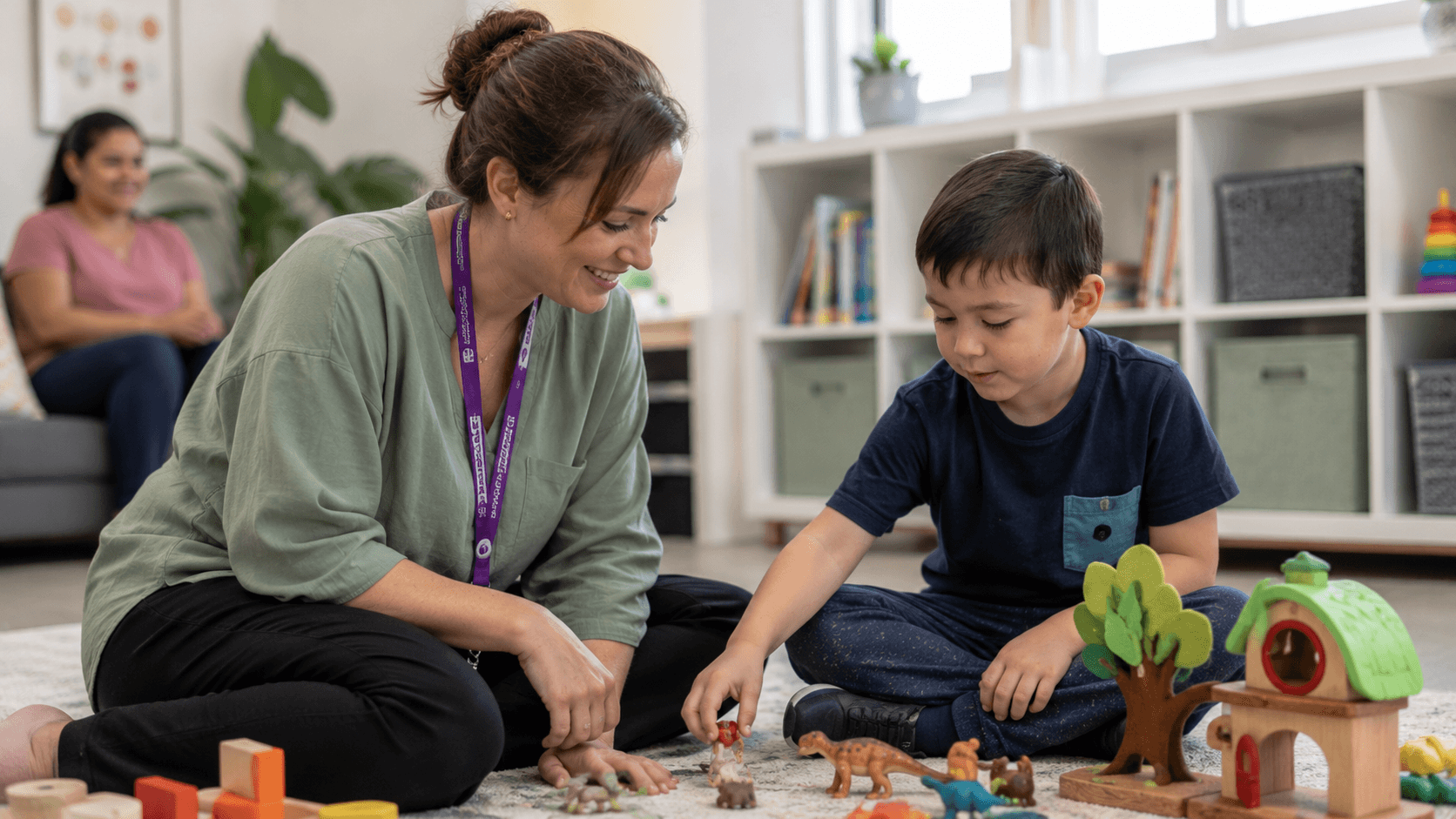 An early childhood key worker playing with a young child